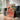 Woman with cat in living room with warm earth tones by Caroline Bonne Müller - Kuriosis Fine Art GmbH